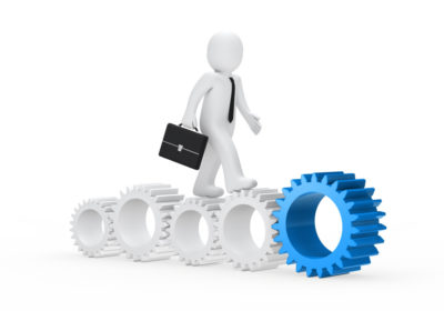 worker-walking-along-gears-different-sizes